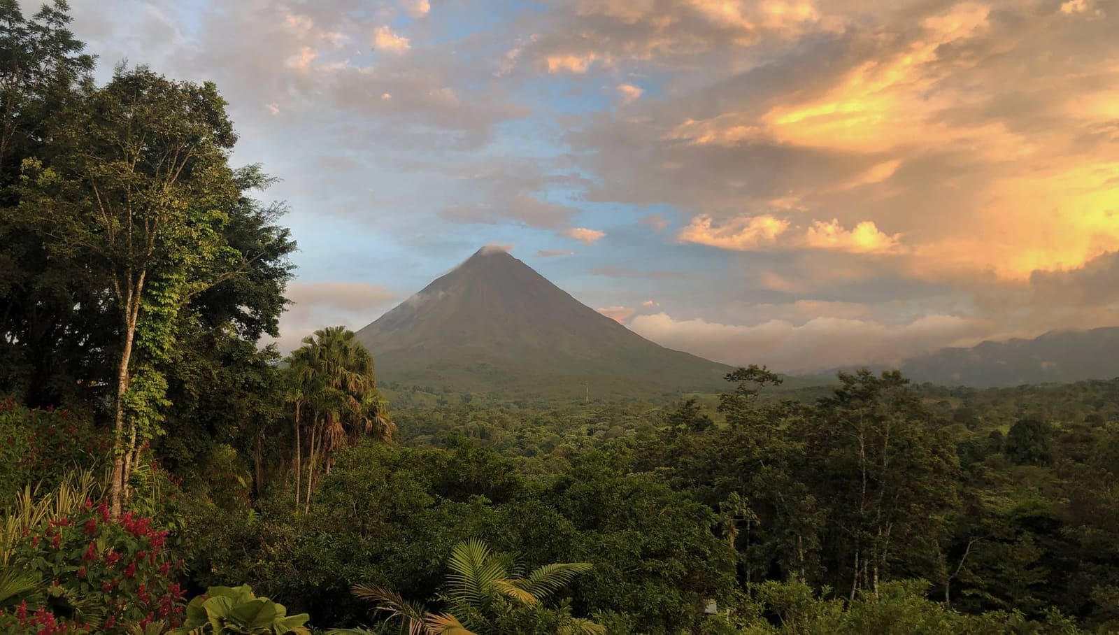 Arenal Volcano at sunset over the forest